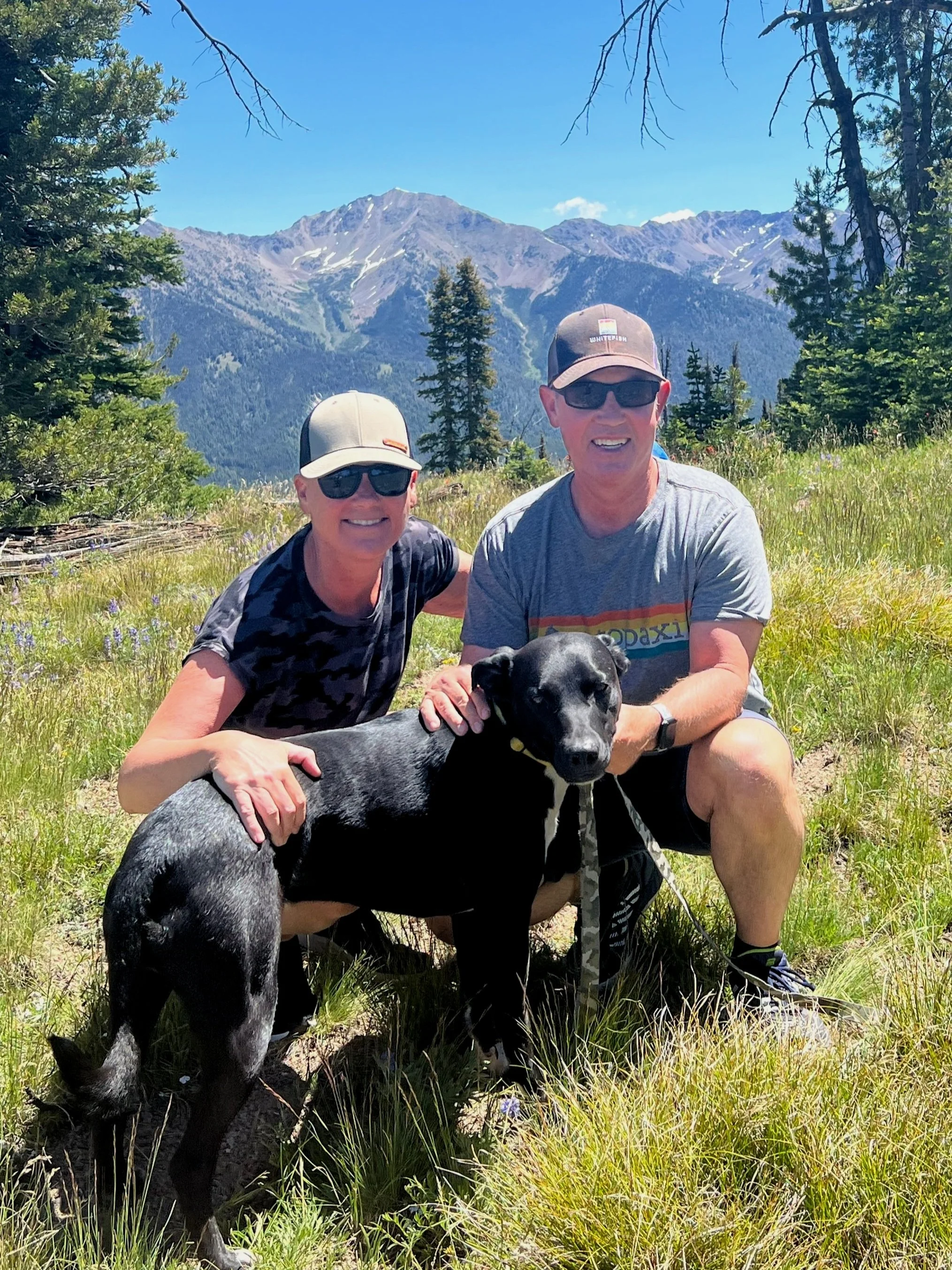 Jen and partner with dog in the mountains